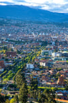 View of the city of Cuenca Ecuador with its many churches and rooftops on a cloudy and sunny day