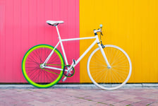 City bicycle fixed gear on yellow and red wall