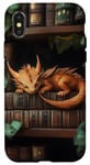 Coque pour iPhone X/XS Petit dragon endormi sur une bibliothèque