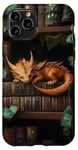 Coque pour iPhone 11 Pro Petit dragon endormi sur une bibliothèque