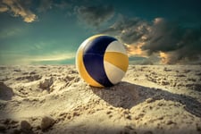 Beach Volleyball Game ball under sunlight and blue sky