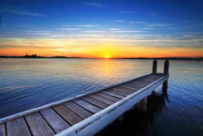 Setting sun behind the boat jetty Lake Maquarie