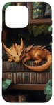 Coque pour iPhone 16 Pro Max Petit dragon endormi sur une bibliothèque