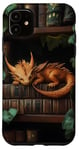 Coque pour iPhone 11 Petit dragon endormi sur une bibliothèque