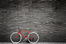 Black and white photo of red bicycle - vintage film grain filter effect styles