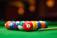 Billiard balls in a green pool table