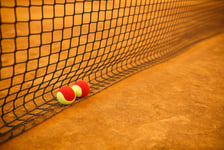 Tennis red ball on a clay tennis court orange color