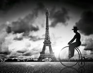 Man on retro bicycle next to Effel Tower Paris France