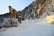 Apuan Alps Carrara Tuscany Italy  An excavator in a quarry of white Carrara marble In the mountains of the Apuan Alps above the city of Carrara white marble has been mined since Roman times