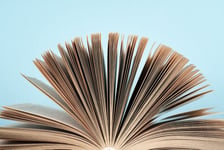 Book stacking Open book hardback books on wooden table and blue background Back to school Copy space for text