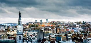 Tower of Notre-Dame des Rcollets church and cityscape of Verviers with a dramatic sky