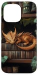 Coque pour iPhone 14 Pro Max Petit dragon endormi sur une bibliothèque