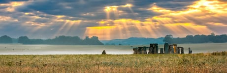 Amesbury Wiltshire United Kingdom - August 14 2016 Cloudy sunrise over Stonehenge - prehistoric megalith monument arranged in circle