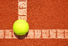 Tennis ball on a tennis clay court