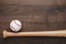 Closeup of baseball bat and ball on wooden table with copy space