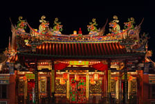 Decorated roof and second floor of traditional old chinese temple Seh Tek Tong Cheah Kongsi in Georgetown Penang Malaysia UNESCO world heritage site Night view