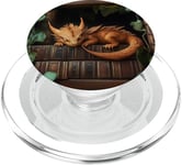 Petit dragon endormi sur une bibliothèque PopSockets PopGrip pour MagSafe