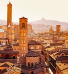 Bologna cityscape with towers and buildings San Luca Hill in background