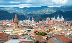 View of the city of Cuenca Ecuador with its many churches and rooftops on a cloudy day