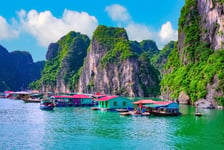 Floating fishing village rock island in Halong Bay Vietnam Southeast Asia UNESCO World Heritage Site Junk boat cruise to Ha Long Bay Landscape Popular asian landmark famous destination of Vietnam